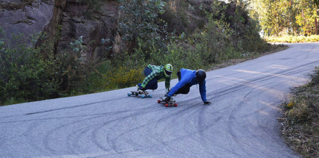 Downhill longboarders displaying good safety care. 