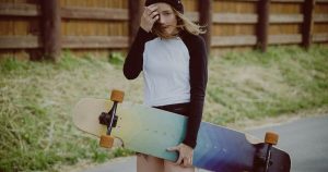 A woman holding her longboard.